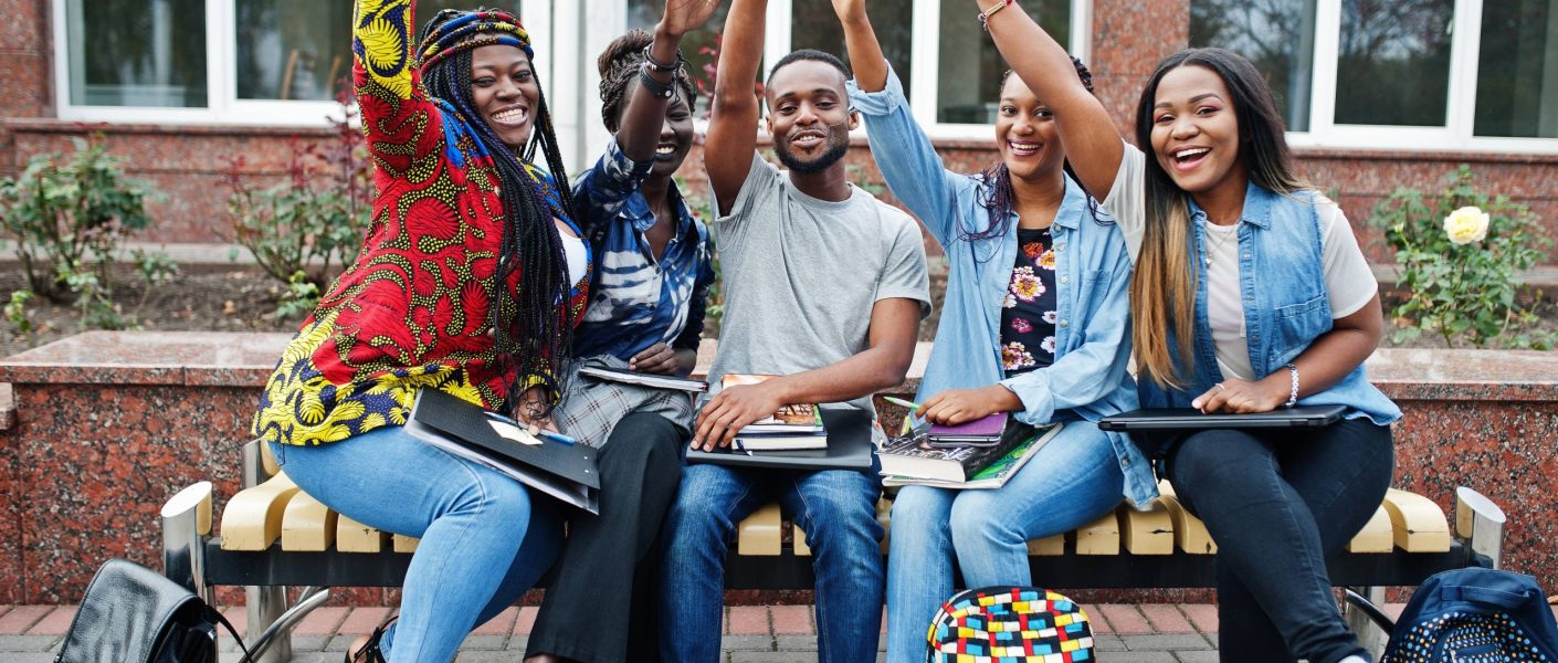 group-five-african-college-students-spending-time-together-campus-university-yard-black-afro-friends-studying-bench-with-school-items-laptops-notebooks (1)