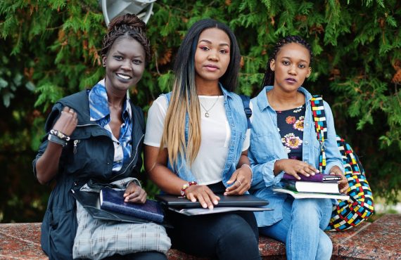three-african-students-female-posed-with-backpacks-school-items-yard-university (1)